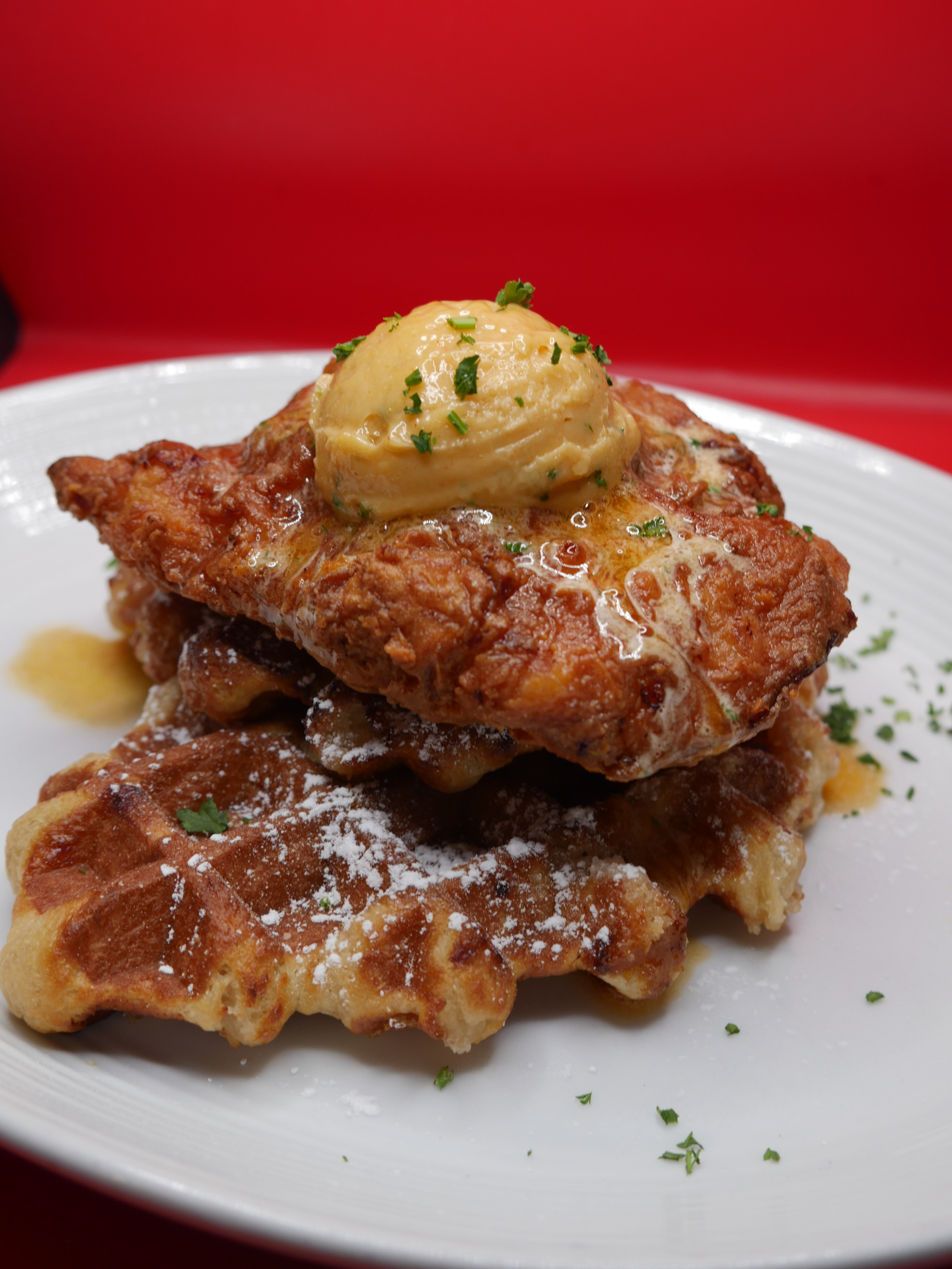 Chicken & waffles with honey butter, real maple syrup, and powdered sugar